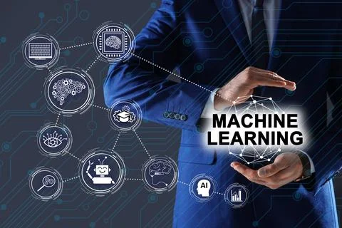 Man demonstrating machine learning model with linked icons on dark background Stock Photos