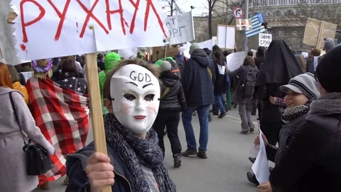 A man at a demonstration with a poster looks into the camera. Stock Footage 75288817