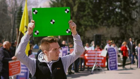 Man on demonstration standing hold track points chroma key billboard. Angry 4k. Stock Footage 106621908