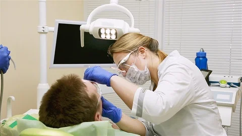A man in the dental office drilling teeth Stock Footage 109420053