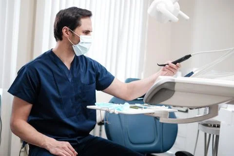 Man dentist working in private practice. Stock Photos