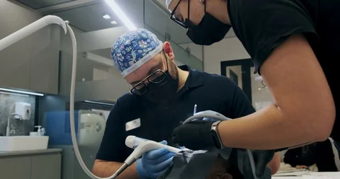 Man dentist's working at office. Two doctors of a dentist do air flow teeth Stock-Footage 129611029