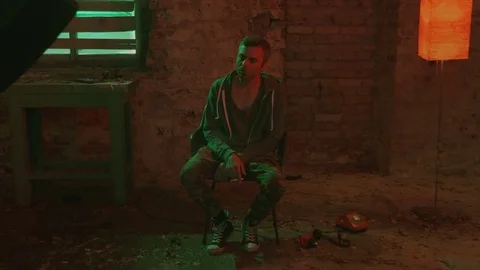 A man in a depression under the influence of various drugs. Stock Footage 83108158