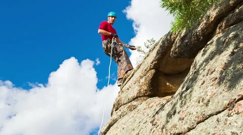 Man descends from the top of the cliff Stock Footage 40617617
