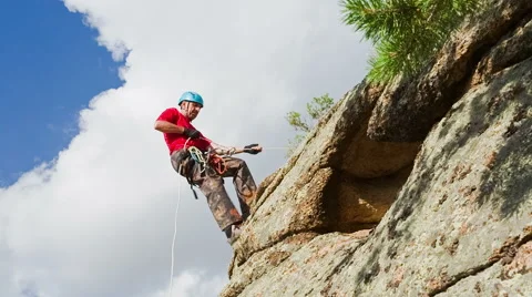 Man descends from the top of the cliff Stock Footage 40617646