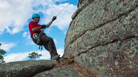 Man descends from the top of the cliff Stock Footage 40617714