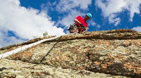 Man descends from the top of the cliff Stock Footage 40617799