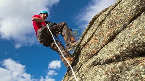 Man descends from the top of the cliff Stock Footage 40617862