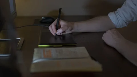 Man designer working on a computer with a graphics tablet Stock Footage 127644475