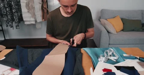 Man designer working with fabric creates clothes collection in the studio Stock-Footage 220147155