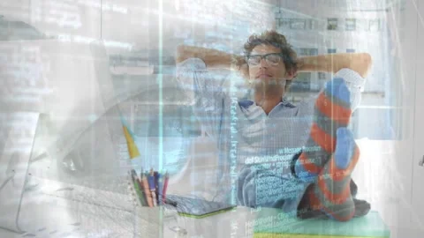 Man at desk pausing office work, lifting feet showing striped socks, resting, Stock Footage 331380265