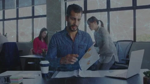Man at desk reading folded sheet and unfolding stained pages pointing and 動画素材 329946348
