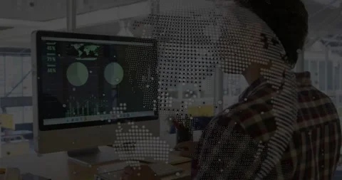 Man at desk switching data dashboard to document, typing while dotted world-map Stock Footage 331227427