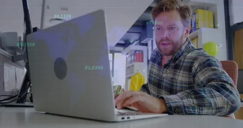 Man at desk typing and leaning in, causing animated tech charts overlaying Stock Footage 331379762