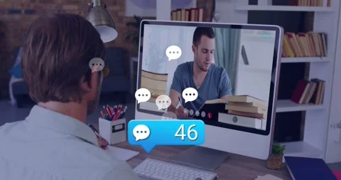 Man at desk watching screen taking notes for study, chat icon appearing near Stock Footage 331615089