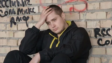 A man in despair on an abandoned building. full hd video Stock Footage 73579885