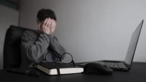 Man in despair after bad work news, taking off glasses and covering face in home 库存影片 329626589