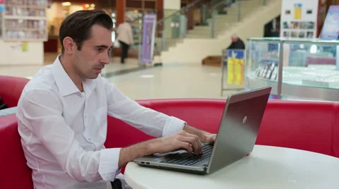 Man in despair and hesitant at work with a laptop Stock Footage 43310161