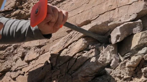Man destroys bedrock using a hammer and chisel Stock Footage 62634468
