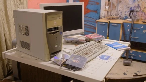 Man destroys an old computer by a sledgehammer in the ruins of an apartment Video stock 90687686
