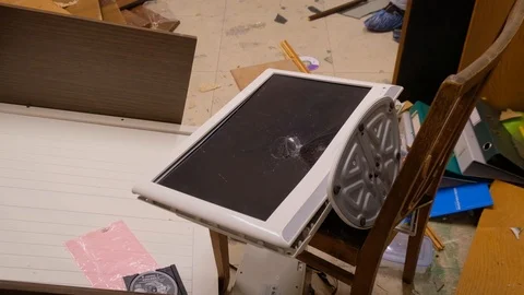 Man destroys an old computer by a sledgehammer in the ruins of an apartment Video stock 90687809