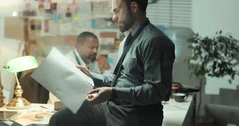 Man, detective and reading document in office for investigation, evidence and Stock Footage 314793946