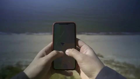 Man determines his geo-position standing on a cliff by the sea. POV shot. Stock Footage 239871333
