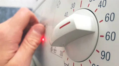 Man determines the washing program for the washing machine, close-up, blurred Video stock 65747018