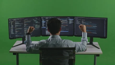 Man Developer Celebrating And Dancing While Write Code With Multiple Computer Stock Footage 249626229
