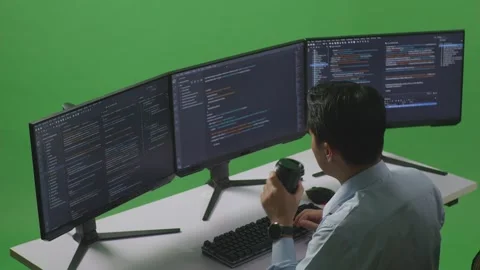 Man Developer Drinking Coffee And Using Computer To Write Code With Multiple Stock Footage 249635503