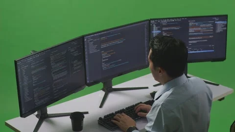 Man Developer Having Headache While Write Code With Multiple Computer Screens Stock Footage 249635199