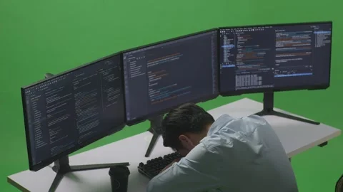 Man Developer Sleeping While Write Code With Multiple Computer Screens In Green Stock Footage 249635956