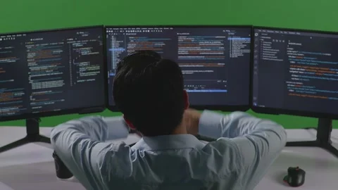 Man Developer Stretching While Write Code With Multiple Computer Screens Stock Footage 249633187