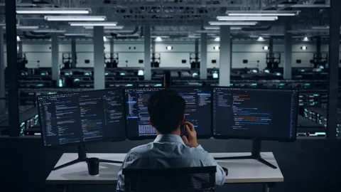 Man Developer Talking On Mobile Phone While Write Code In Data Center Video stock 270226819