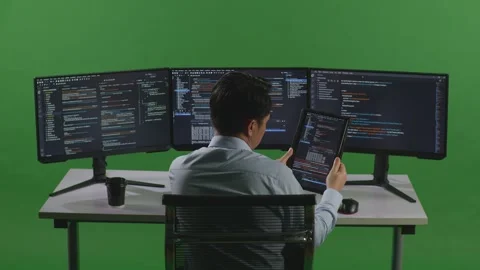 Man Developer Working With Tablet While Write Code With Multiple Computer Stock Footage 249626353