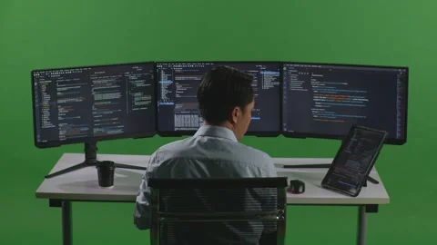 Man Developer Working With Tablet While Write Code With Multiple Computer Video stock 249626409