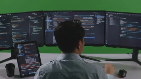 Man Developer Working With Tablet While Write Code With Multiple Computer Stock Footage 249632546