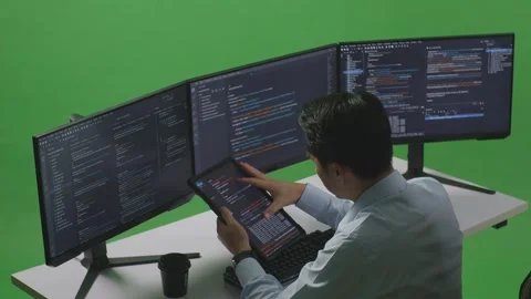 Man Developer Working With Tablet While Write Code With Multiple Computer Stock Footage 249635237