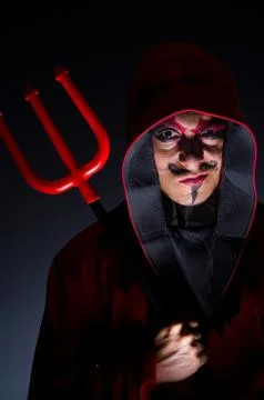 Man in devil costume in halloween concept Stock Photos