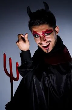 Man in devil costume in halloween concept Stock Photos