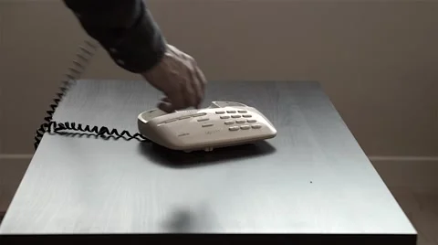 Man dialing a number  and make a call on his table phone Stock Footage 44830883
