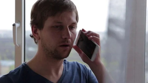 Man dialing phone number and calling on smartphone at home Stock Footage 76116385