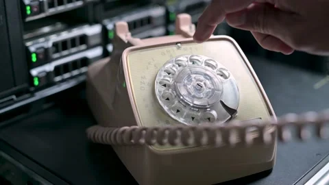 A man dials a number by clicking on the numbers of an old rotary dial telephone Stock Footage 139837033