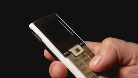A man dials a number on a push-button mobile phone. Vídeos de archivo 233626700
