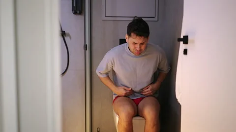 Man with digestive problem sitting on toilet Vídeo Stock 342926456