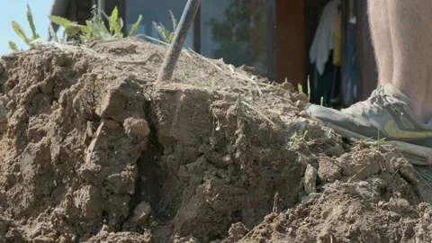 Man digging clay soil heap with shovel on sunny day close up. Hard work concept. Stock Footage 134139357