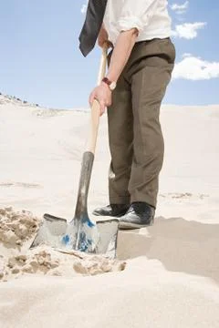 Man digging in desert Stock Photos