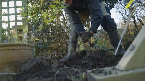 A man is digging in the dirt with a shovel Stock Footage 301618684