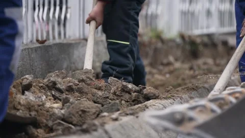 A man is digging in the dirt with a shovel Stock Footage 317317313