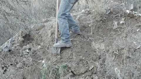 A man digging earth from the mountain Stock Footage 70203439
